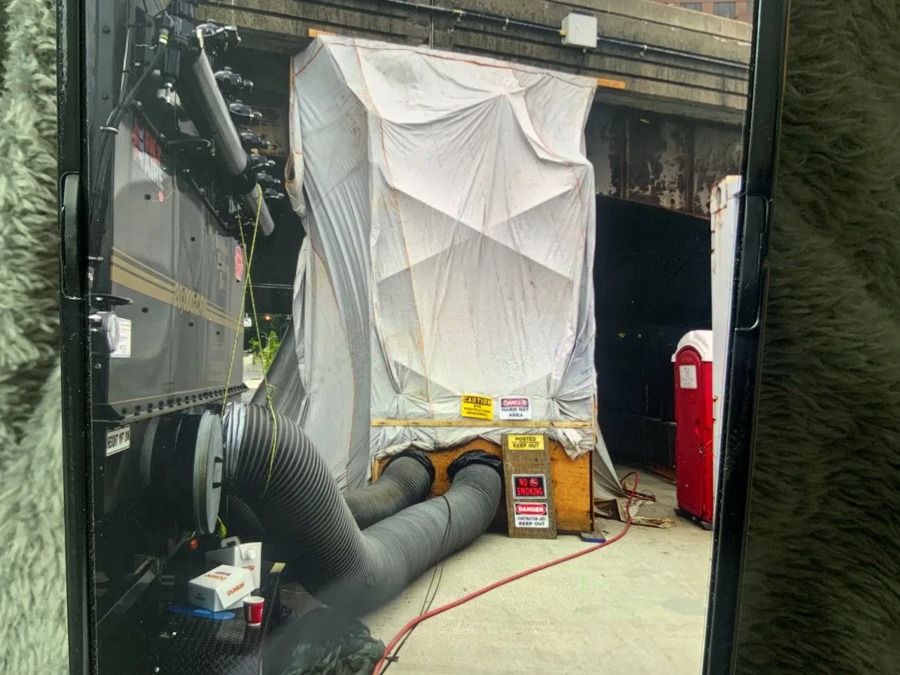 Full containment enclosure with hoses and hazard signage at the Hartford bridge site, Rotha Contracting project