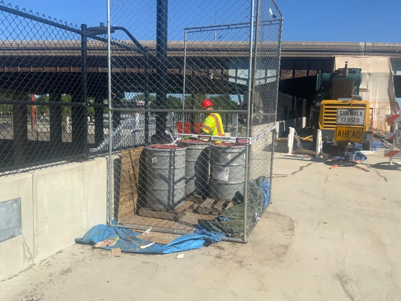 Cristiano & Son crew member in hi-vis and hard hat working a lead-hazard containment area at the Hartford pin-and-hanger bridge site