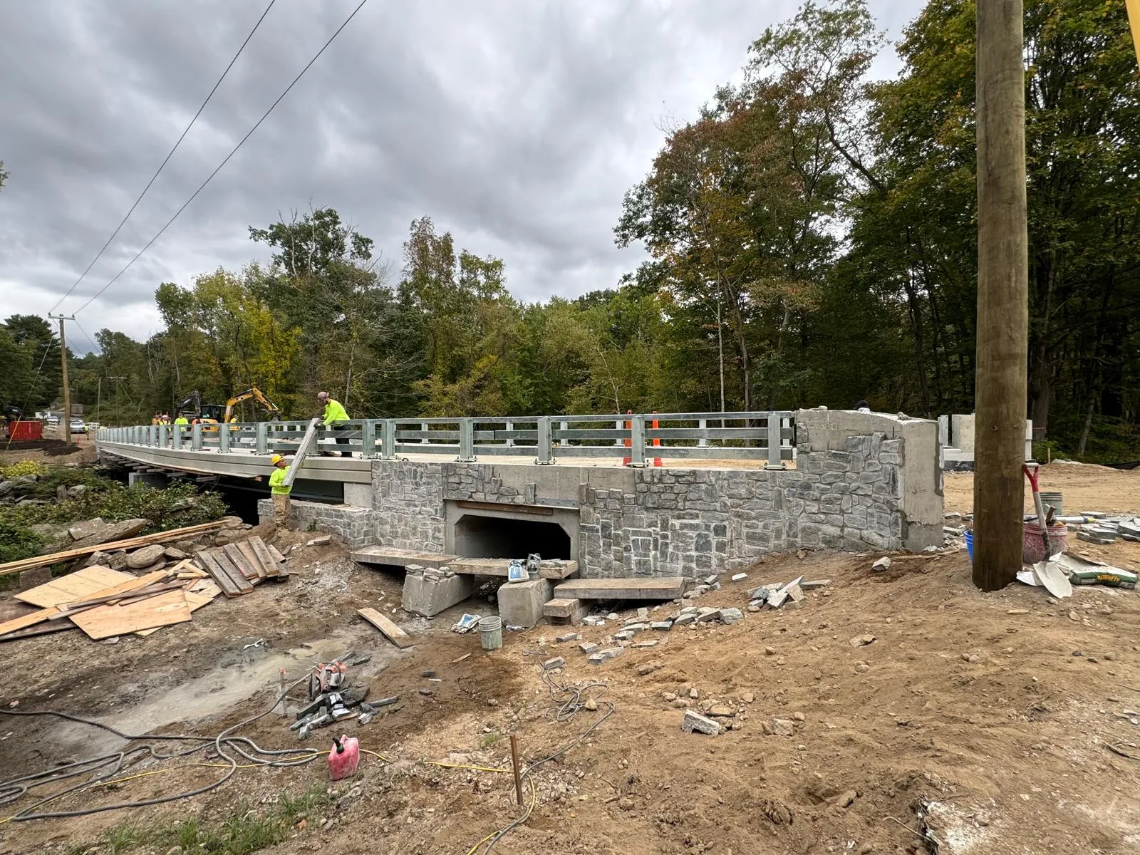 Completed country road bridge with freshly painted green railings