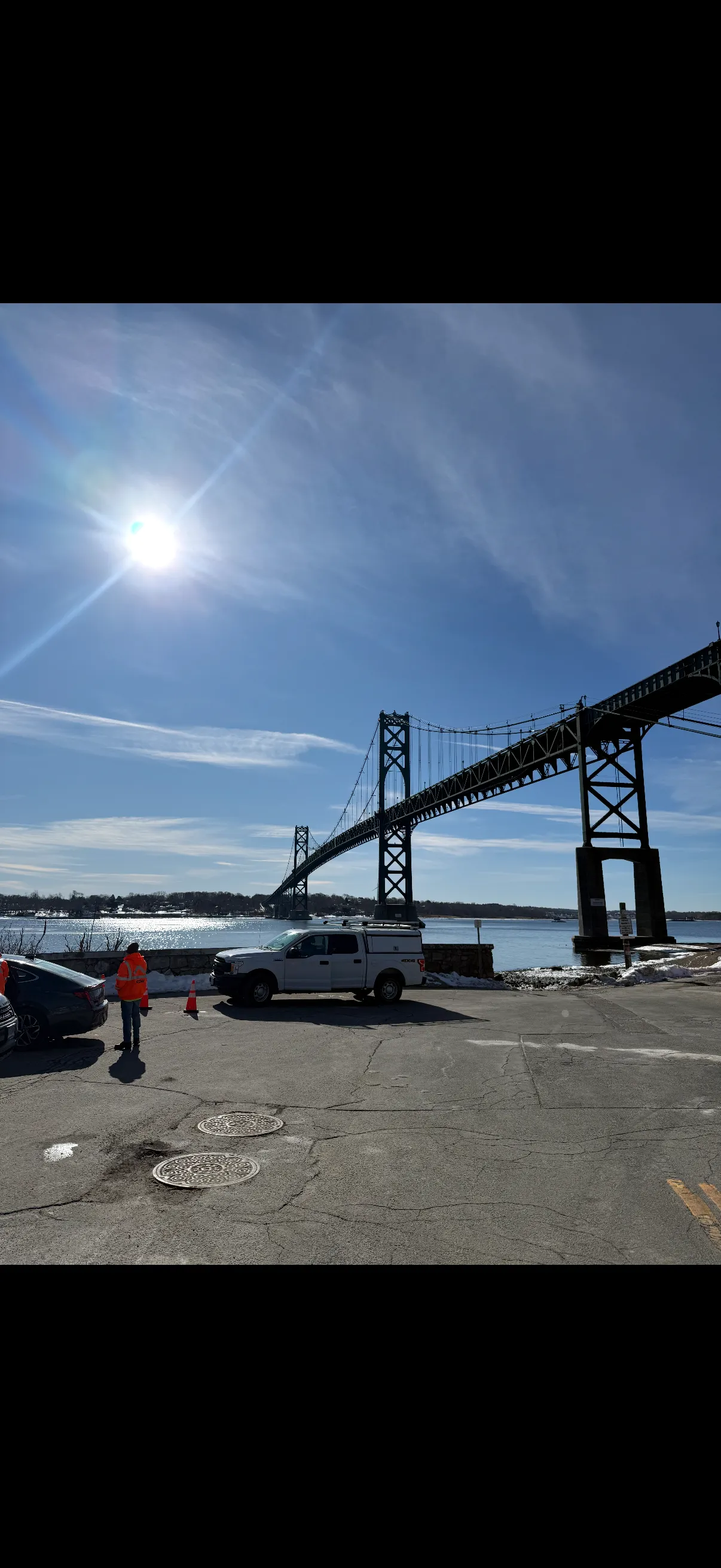 Night bridge painting operations with bucket trucks and work lights