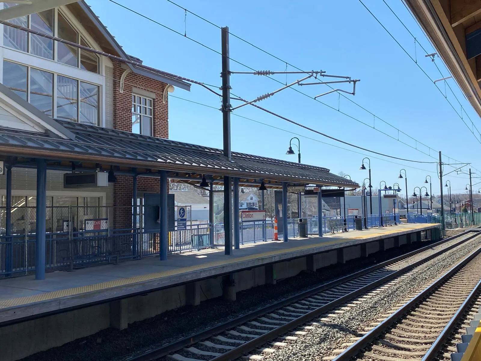 Freshly painted commuter rail station exterior with blue steel columns