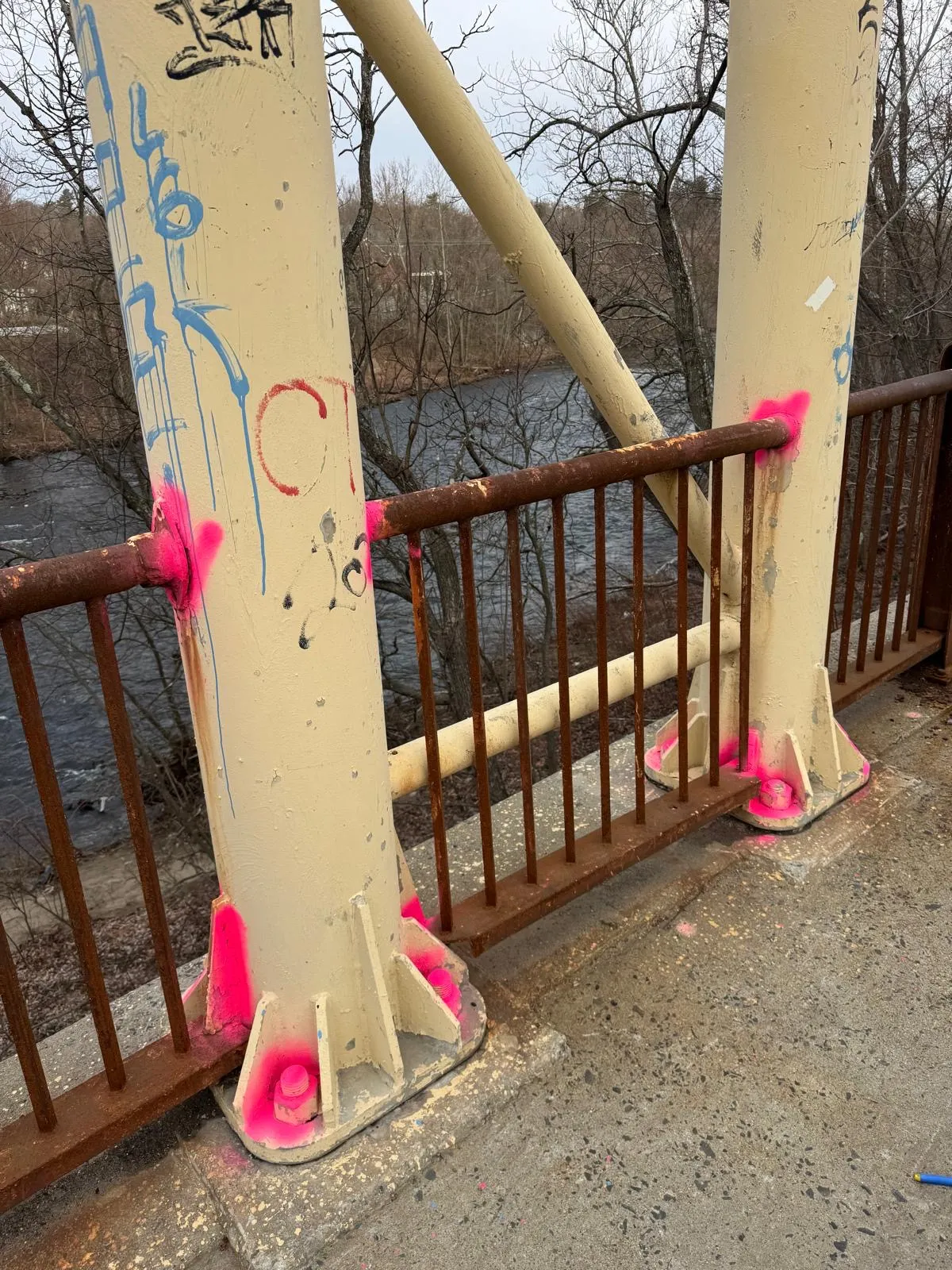 Steel bridge beam being painted inside environmental containment