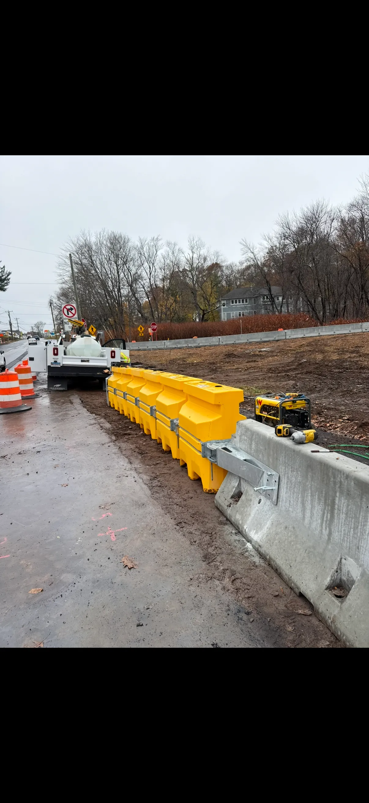 Highway guardrail installation in progress